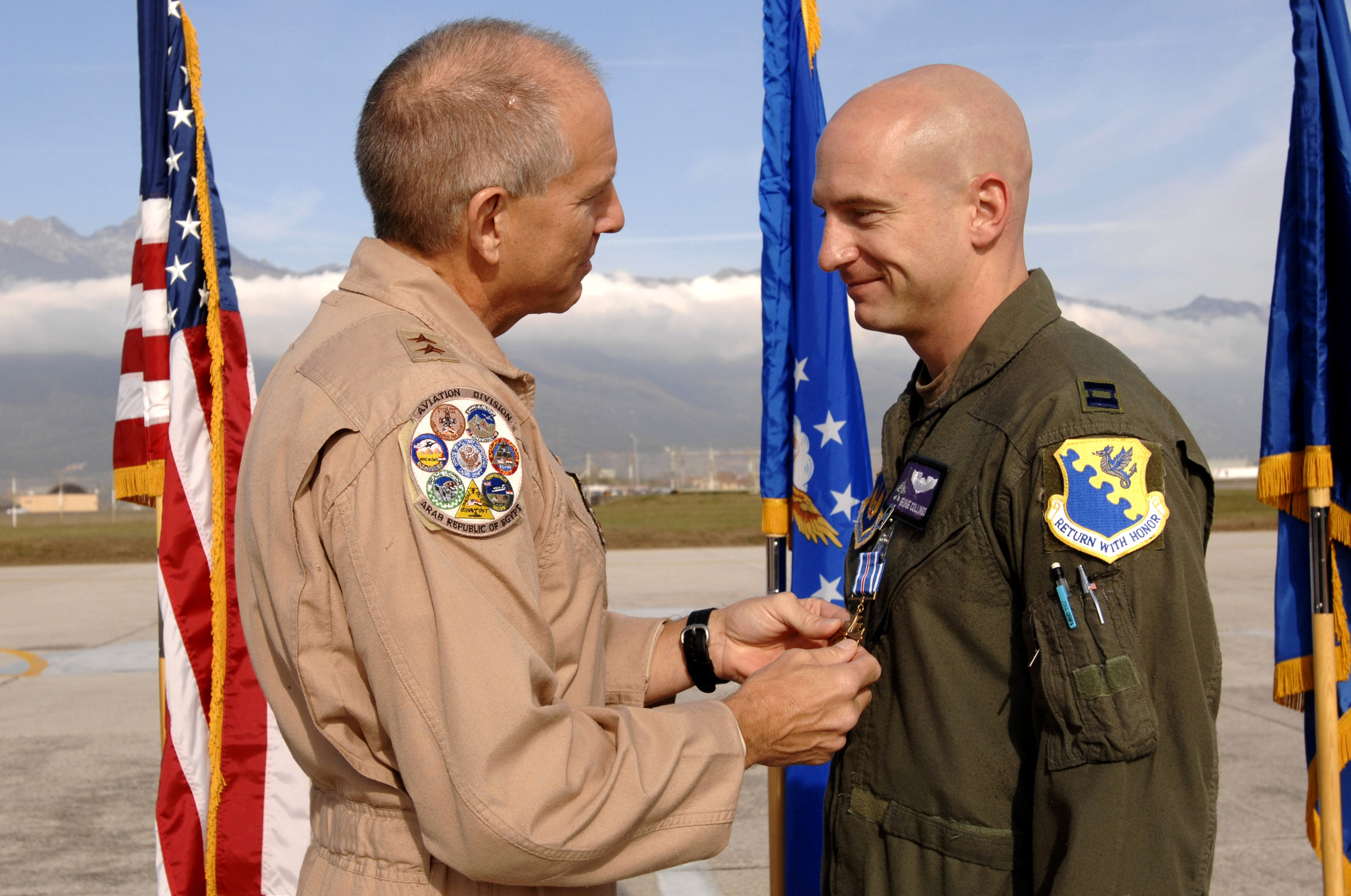 Picture of Capt  GeorgeCollings receiving the Distinguished Flying Cross from his father  Maj. Gen. Michael Collings.