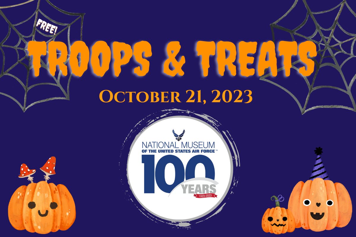 Troops and Treats, October 21 from 10 - 4. Free for ghosts and goblins of all ages. Purple background with spider webs and pumpkins and organge lettering. 