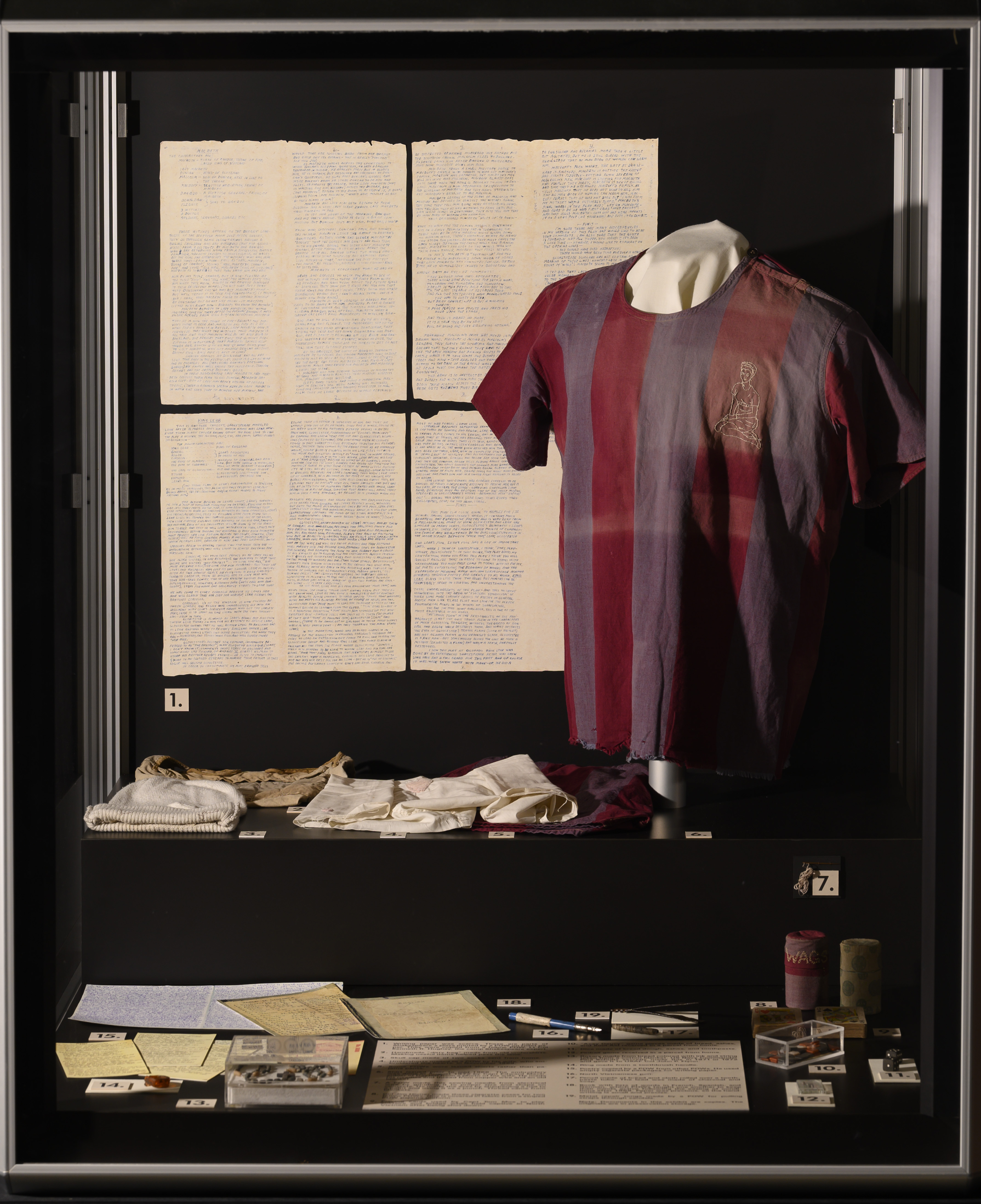 a full picture of the exhibit case containing the sewing needle and thread, as well as other pow artifacts