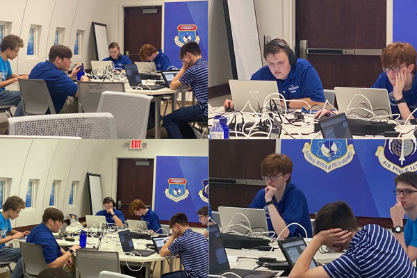 Cyber Patriot team members solve computer challenges