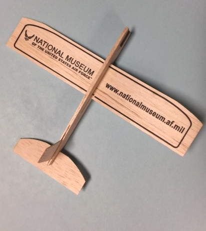 Image of a wooden airplane modle with the museum's logo imprinted on the wings