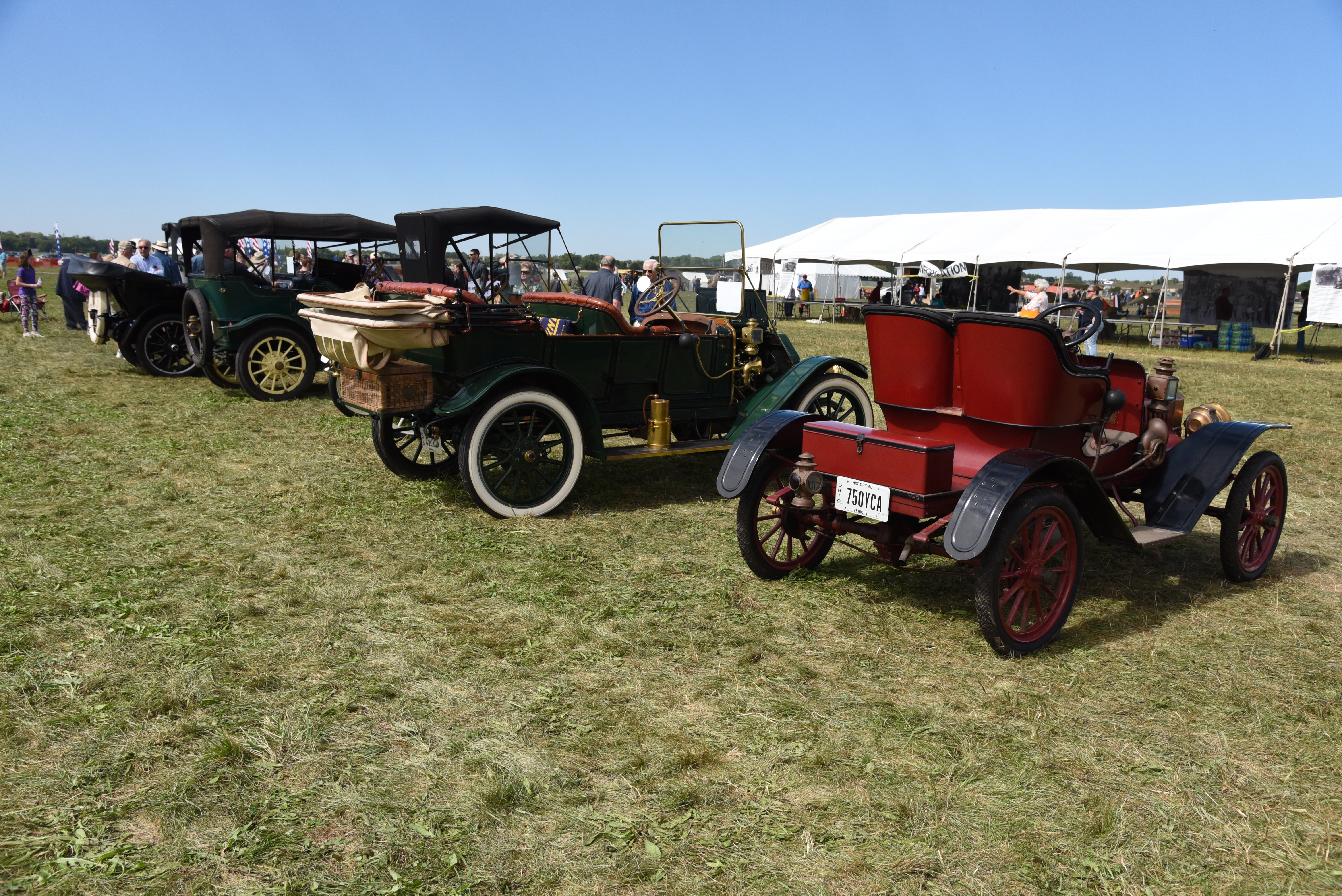 Image of several vintage autos on the lawn of the musem