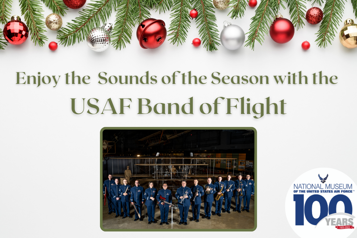 Enjoy the Sounds of the Season with the USAF Band of Flight in green letters with a picture of the band in uniform in front of the Wright 1909 military flyer. Red, gold and silver ornaments hang from garland at the top of the page. 