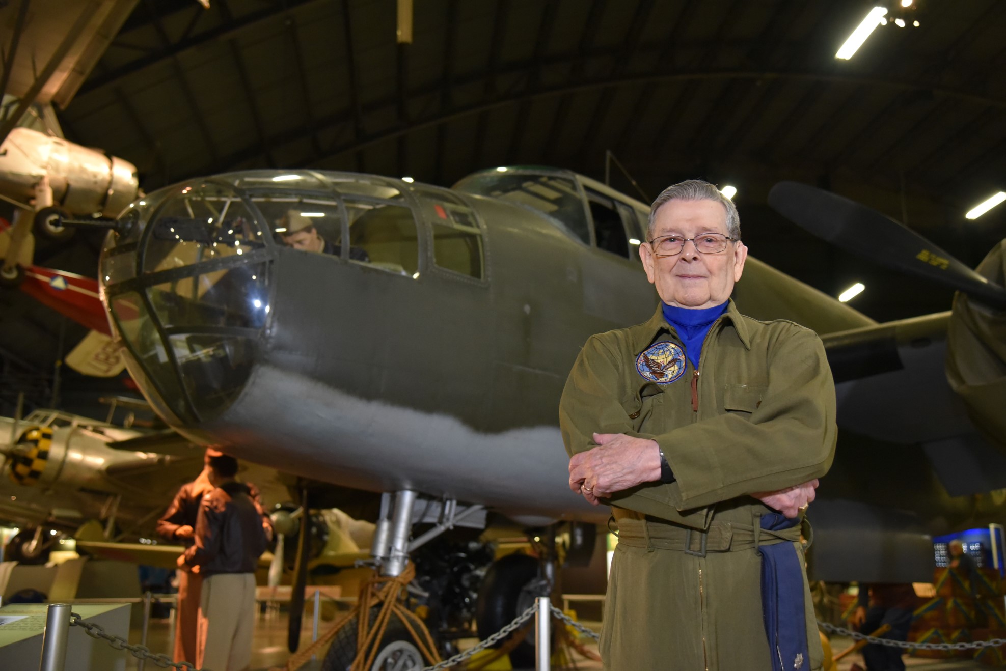 Picture of veteran standing in front of a B-25